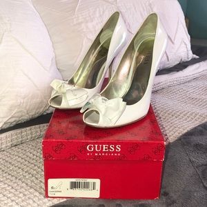 White PTO guess heels with a bow on front of them.